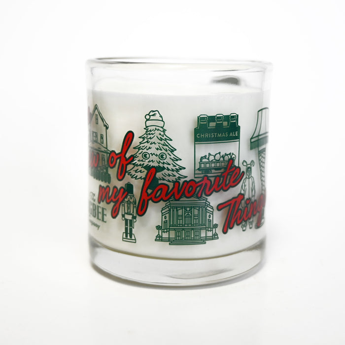 Glass candle with Christmas-themed design and text on a white background