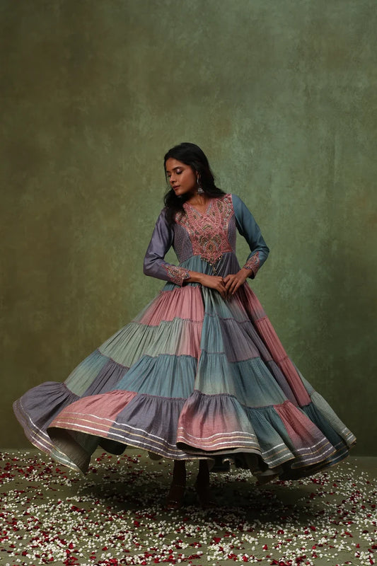 Elegant tiered Anarkali gown in pastel hues featuring an intricately embroidered bodice and flowing gathered skirt.