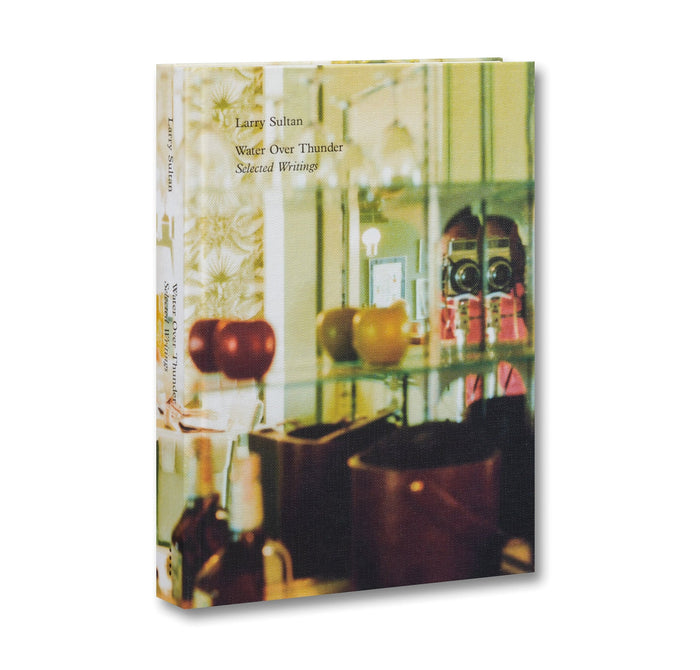 Book cover with a photograph of a room and text 'Larry Sultan Water Over Thunder Selected Works'.