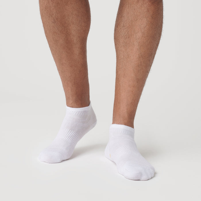 White Ankle Socks 6-Pack on model's feet, showcasing seamless toe design.