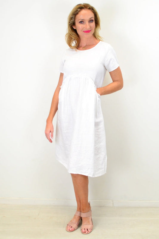 White linen Sunday best tunic dress by Cali&Co, featuring a relaxed fit with long sleeves and a simple, elegant design.