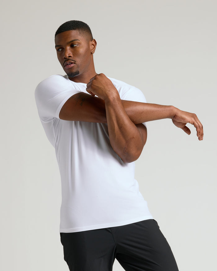 White Tall Active Crew Neck 2.0 worn by athletic man stretching.